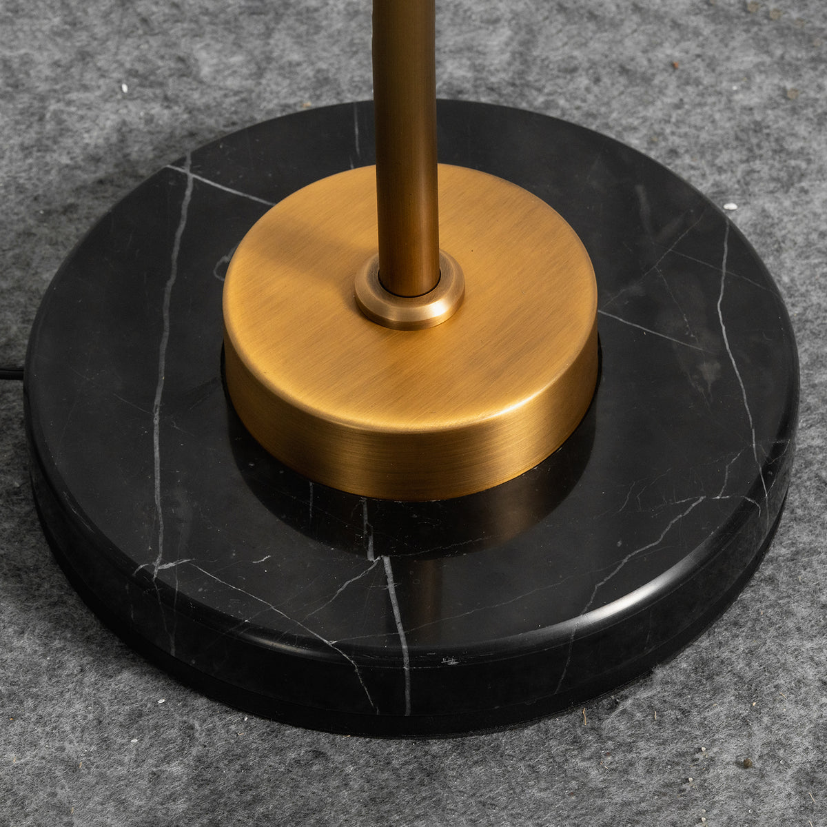 Stellan Alabaster Column Floor Lamp | Natural Alabaster, Brass and Black Metal | Close-up of the heavy circular black base and brass collar detail | Severn Lighting
