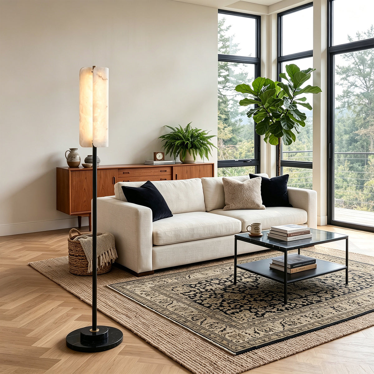 Stellan Alabaster Column Floor Lamp | Natural Alabaster, Brass and Black Metal | Placed next to a beige sofa in a modern living room | Severn Lighting