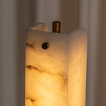 Stellan Alabaster Column Floor Lamp | Natural Alabaster, Brass and Black Metal | Close-up detail of the illuminated translucent alabaster grain | Severn Lighting
