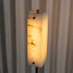 Stellan Alabaster Column Floor Lamp | Natural Alabaster, Brass and Black Metal | Medium shot highlighting the warm glowing alabaster column | Severn Lighting