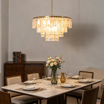 Thalassa Tiered Capiz Shell Chandelier | Capiz Shell, Metal | Suspended over an elegant contemporary white dining table and chairs set next to a dark wood sideboard cabinet | Severn Lighting