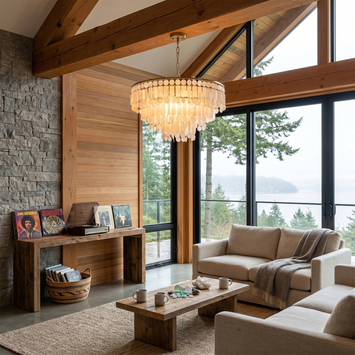 Thalassa Tiered Capiz Shell Chandelier | Capiz Shell, Metal | Featured as statement overhead lighting in a cozy rustic living room with a stone wall fireplace and sloping wooden ceilings | Severn Lighting