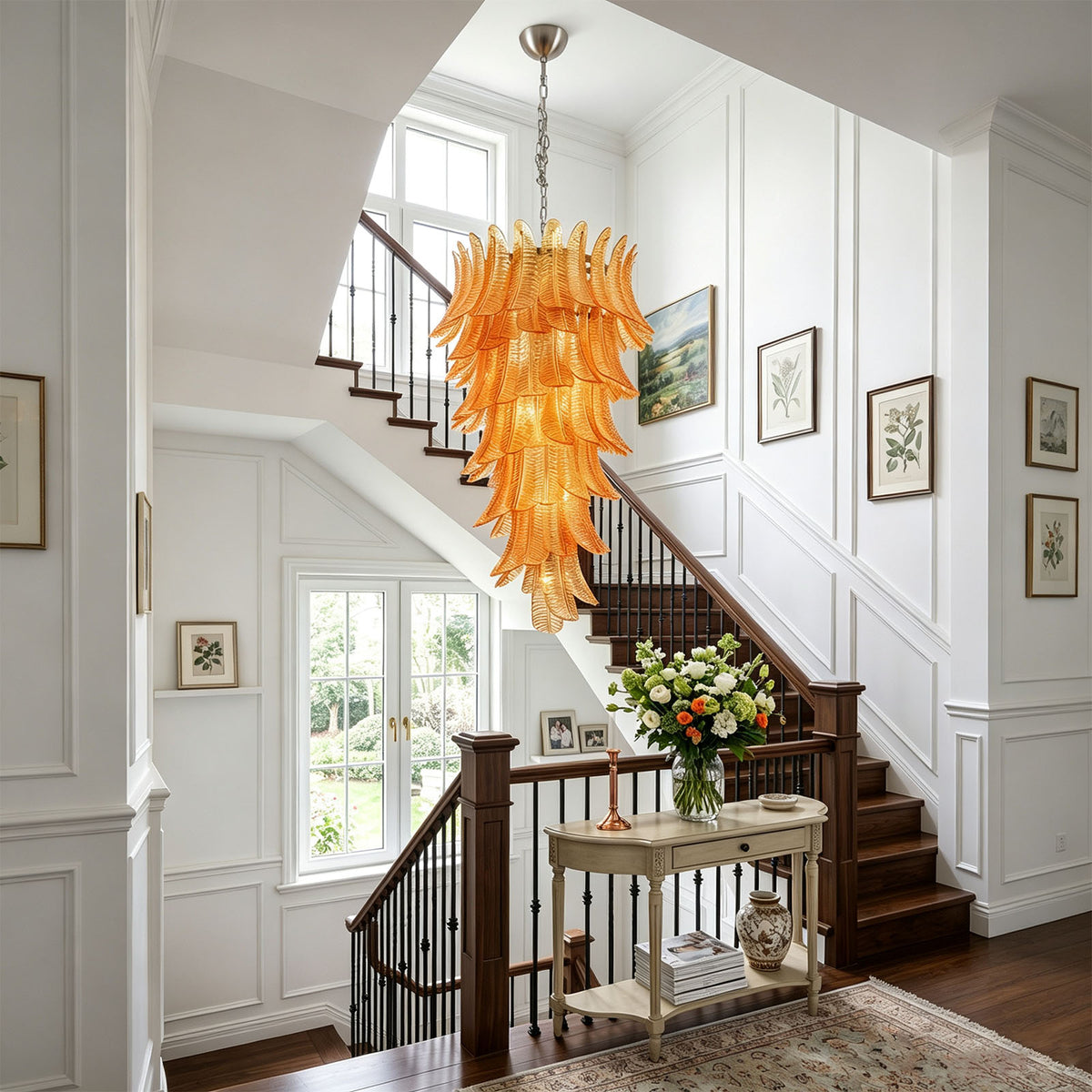 Thessaly Amber Glass Plume Chandelier | Amber Glass and Brass | Hanging above a wooden staircase in an elegant entryway | Severn Lighting