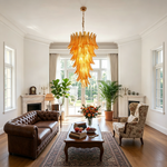 Thessaly Amber Glass Plume Chandelier | Amber Glass and Brass | Enhancing a bright living room featuring a brown leather sofa | Severn Lighting