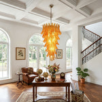 Thessaly Amber Glass Plume Chandelier | Amber Glass and Brass | Displayed in a spacious room with a coffered ceiling and arched windows | Severn Lighting