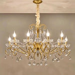 Torvald Scrolled Crystal Brass Chandelier | Cut Crystal and Brass | Large size variant illuminated full view against a warm neutral wall | Severn Lighting