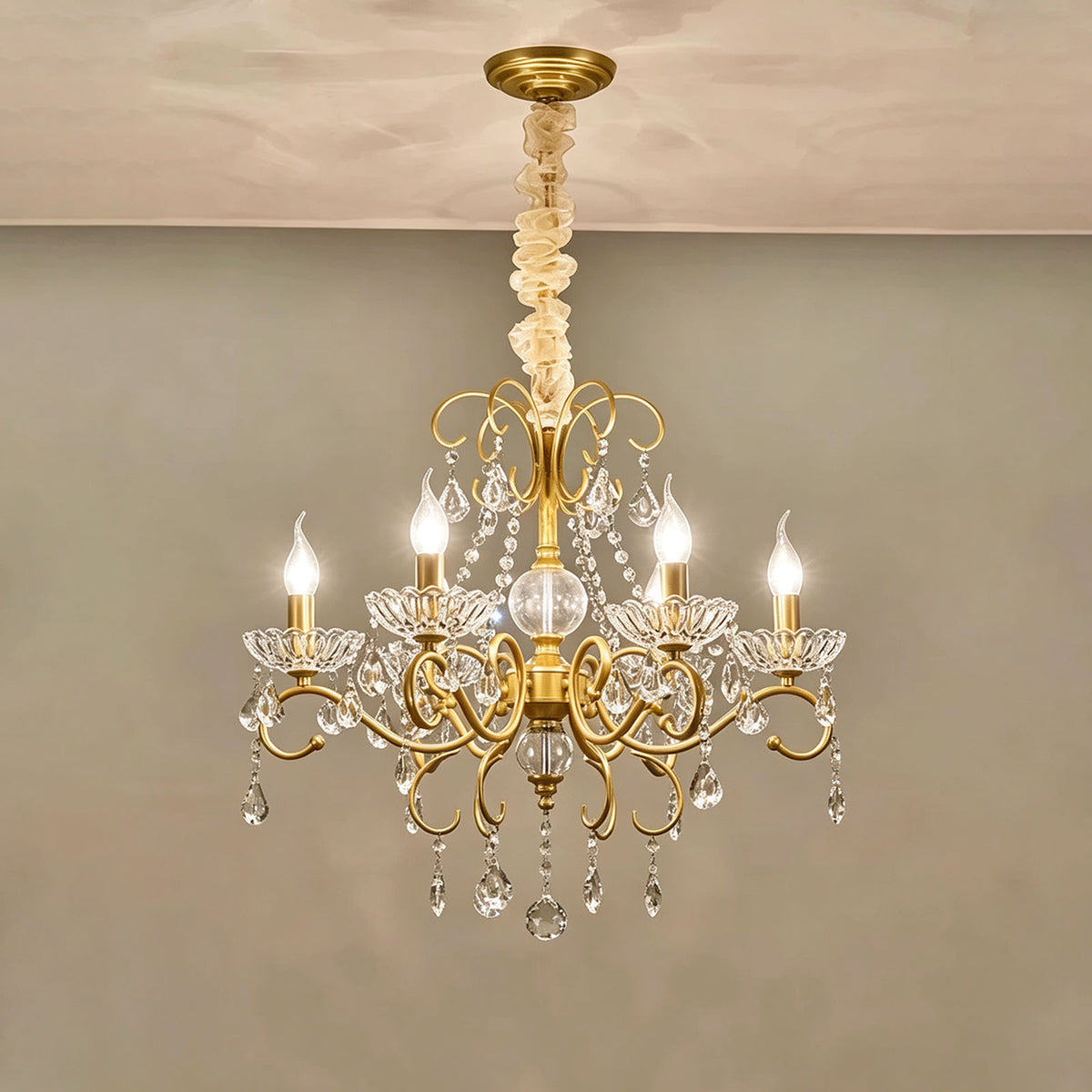 Torvald Scrolled Crystal Brass Chandelier | Cut Crystal and Brass | Compact size variant full view glowing brightly on a neutral backdrop | Severn Lighting