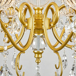 Torvald Scrolled Crystal Brass Chandelier | Cut Crystal and Brass | Detail shot showing the ornate brass scroll arms and central crystal sphere | Severn Lighting