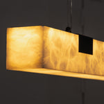 Vale Alabaster Linear Glow Pendant Lighting | Natural Alabaster and Black Metal | Macro close-up shot focusing on the glowing translucent alabaster texture with rich organic veining | Severn Lighting