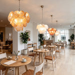 Vaucelle Swirled Glass Disc Tiered Chandelier | Swirled Glass and Brass | Multiple chandeliers installed in a restaurant dining space | Severn Lighting