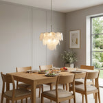 Vaucelle Swirled Glass Disc Tiered Chandelier | Swirled Glass and Brass | Illuminating a modern dining room above a wooden dining set | Severn Lighting