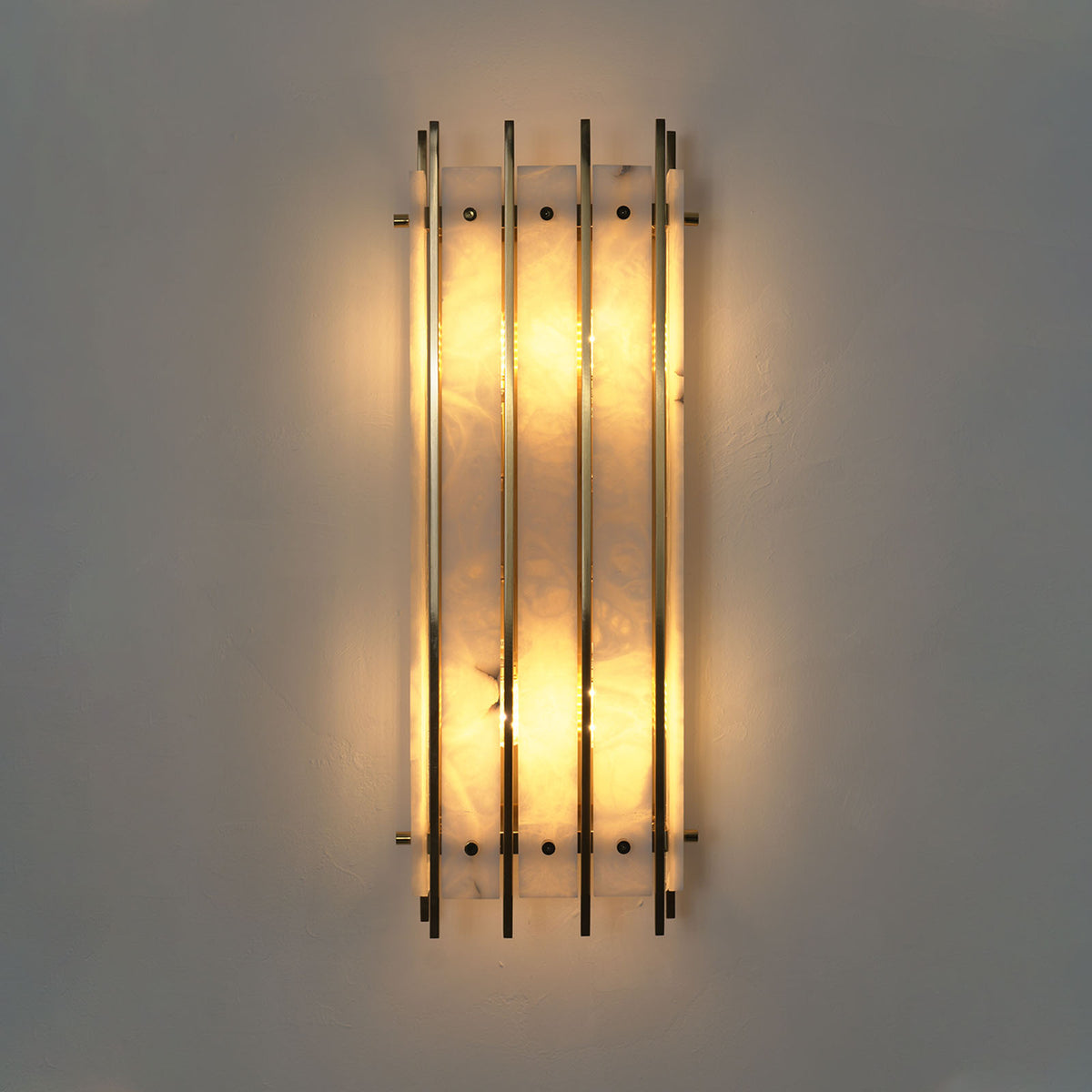 Veraune Bar Wall Sconce | Alabaster and Brass | Front view illuminated on light wall with radiant glow | Severn Lighting