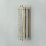 Veraune Bar Wall Sconce | Natural Stone and Brass | Angled three-quarter perspective on grey wall, unlit | Severn Lighting