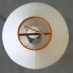 Verena Ribbed Paper Column Floor Lamp | Ribbed Paper and Metal Tripod Legs | Top-down overhead view looking into the circular wooden rim and internal wiring framework of the lamp shade | Severn Lighting