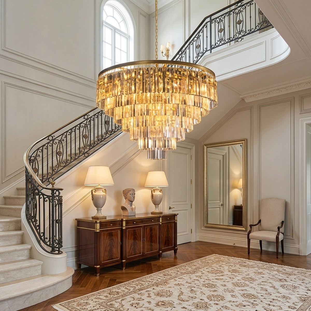 Verity Fringed Glass Tier Chandelier | Fringed Glass and Brass | Lighting a grand foyer near a grand staircase and wooden credenza | Severn Lighting