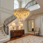 Verity Fringed Glass Tier Chandelier | Fringed Glass and Brass | Lighting a grand foyer near a grand staircase and wooden credenza | Severn Lighting