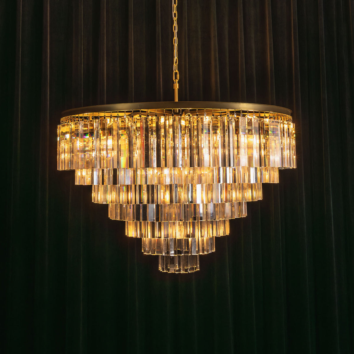 Verity Fringed Glass Tier Chandelier | Fringed Glass and Brass | Full product view illuminated with a warm glow on a dark background | Severn Lighting