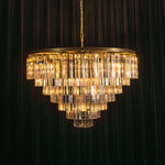 Verity Fringed Glass Tier Chandelier | Fringed Glass and Brass | Full product view illuminated with a warm glow on a dark background | Severn Lighting