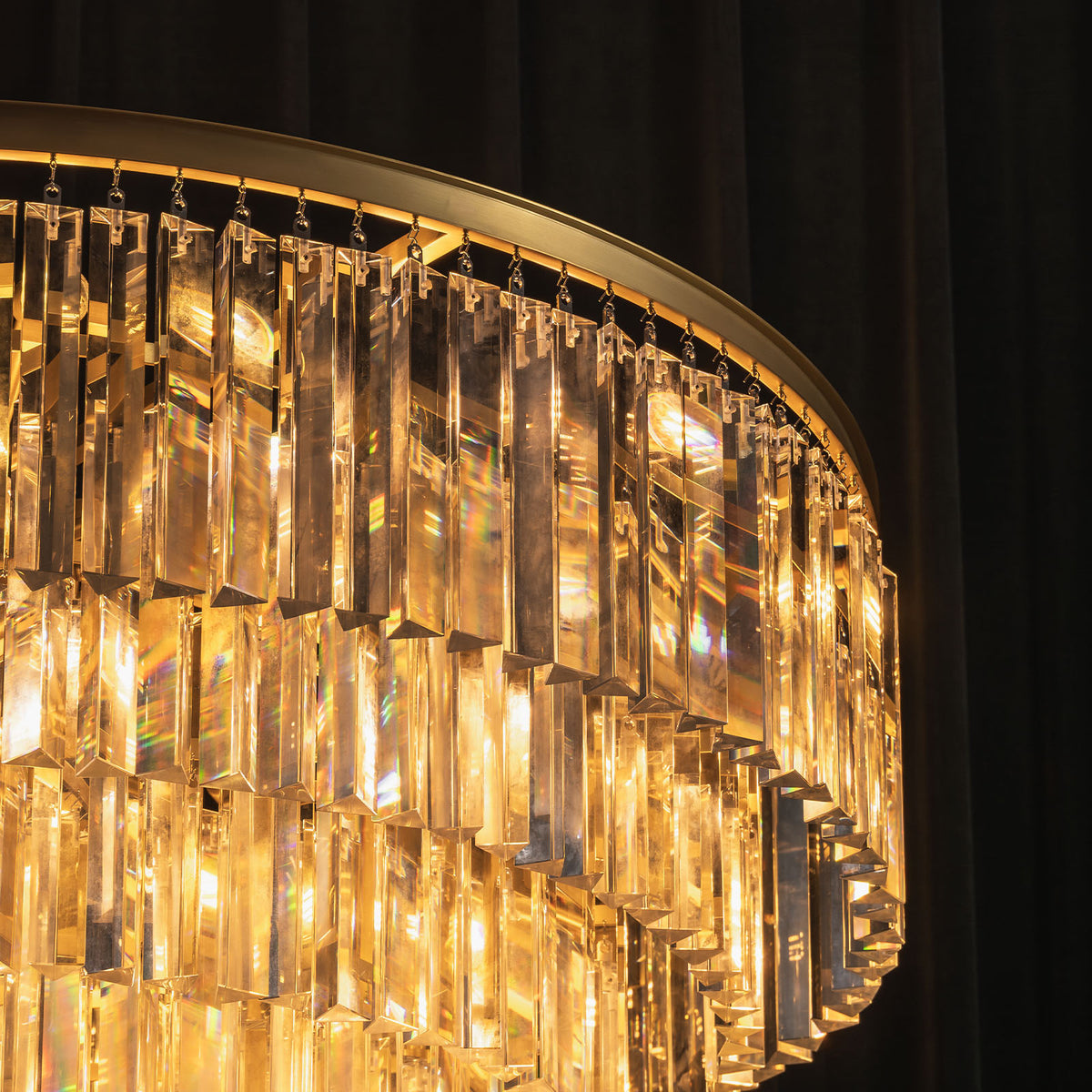 Verity Fringed Glass Tier Chandelier | Fringed Glass and Brass | Close-up view of the illuminated brass rim and fringed glass layers | Severn Lighting