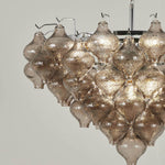 Vespera Tiered Smoked Glass Chandelier | Textured Smoked Glass | Close-up side view highlighting the dramatic tiered arrangement of the glowing teardrop globes | Severn Lighting