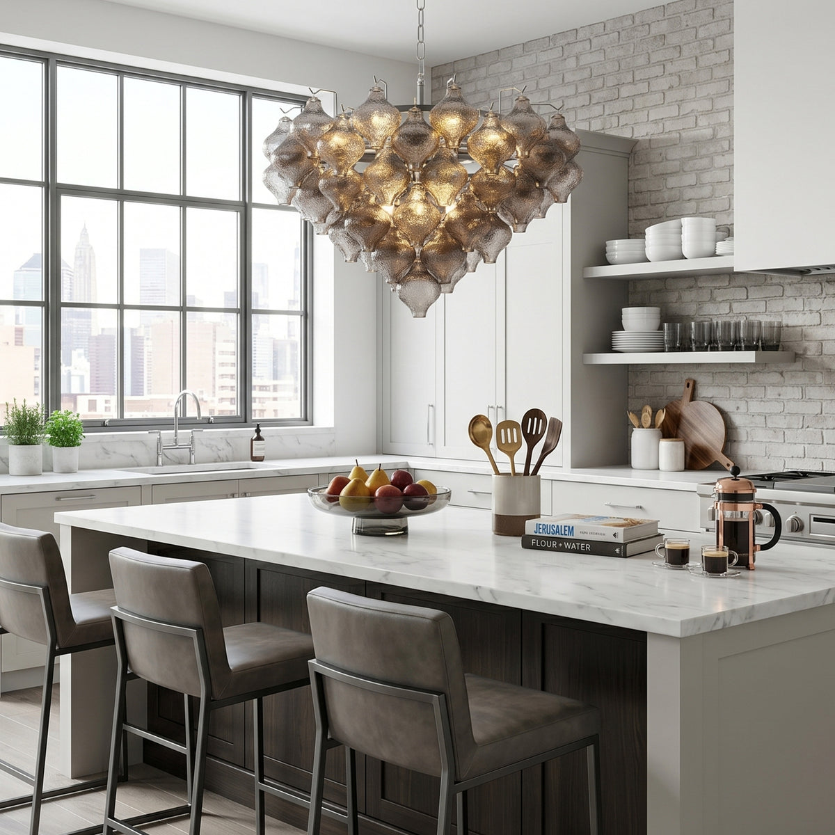 Vespera Tiered Smoked Glass Chandelier | Textured Smoked Glass | Illuminating a contemporary kitchen island with grey leather bar stools and open shelves | Severn Lighting