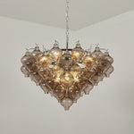 Vespera Tiered Smoked Glass Chandelier | Textured Smoked Glass | Full view of the fixture hanging from a plain ceiling fully lit with a warm golden ambiance | Severn Lighting