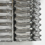 Vespera Tiered Smoky Glass Wall Lamp | Glass, Metal | Extreme macro focus on the undulating wavy edge texture of the glossy clear smoky glass rods under studio light | Detail shot | Severn Lighting