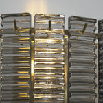 Vespera Tiered Smoky Glass Wall Lamp | Glass, Metal | Detailed close-up showing the golden brass central support structure behind the semi-translucent textured glass panels | Detail shot | Severn Lighting