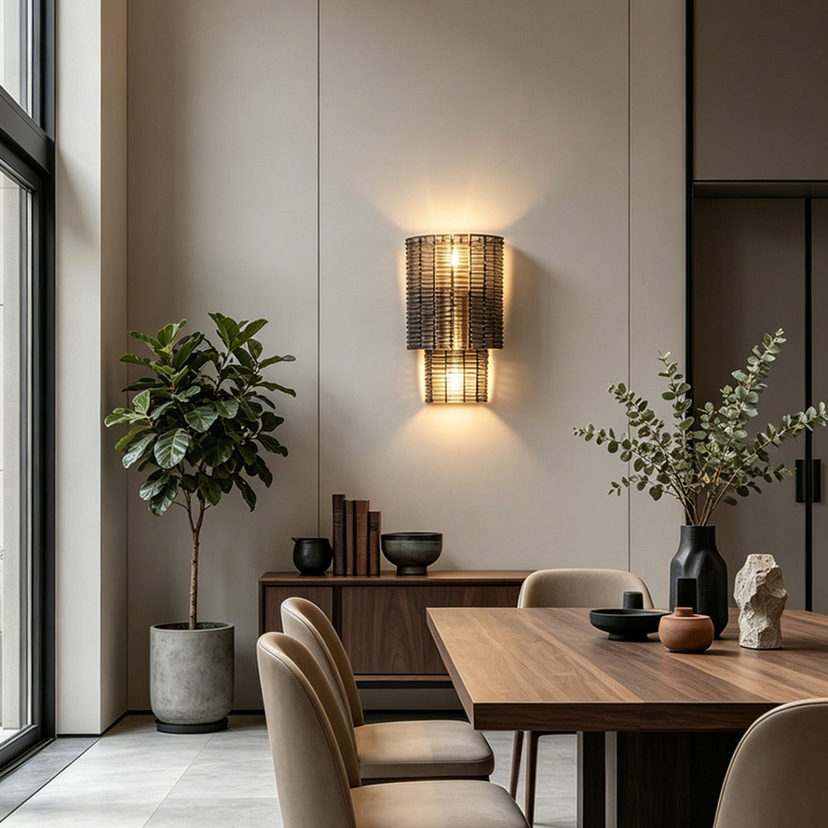 Vespera Tiered Smoky Glass Wall Lamp | Glass, Metal | Casting a warm ambient glow on a wall in a sophisticated contemporary dining room next to a long wooden dining table | Severn Lighting