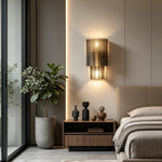 Vespera Tiered Smoky Glass Wall Lamp | Glass, Metal | Positioned as a moody bedtime nightlight over a low-profile walnut wood nightstand next to a modern bed | Severn Lighting