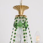Vionne Green Crystal Drop Brass Chandelier | Green Crystal, Clear Glass and Brass | Close-up detail of the top brass crown and hanging green crystal bead chains | Severn Lighting
