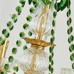 Vionne Green Crystal Drop Brass Chandelier | Green Crystal, Clear Glass and Brass | Close-up view focusing on the draped green crystal bead chains and central column | Severn Lighting