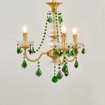 Vionne Green Crystal Drop Brass Chandelier | Green Crystal, Clear Glass and Brass | Compact variant full view glowing softly on a plain grey backdrop | Severn Lighting