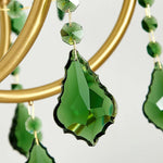 Vionne Green Crystal Drop Brass Chandelier | Green Crystal, Clear Glass and Brass | Macro close-up of a faceted emerald green crystal teardrop pendant | Severn Lighting
