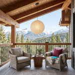 Washi Paper A Pendant Light | Japanese Wabi-Sabi Paper Lantern | Suspended over a cozy outdoor covered balcony lounge with wooden railings and mountain views